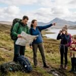 Family studying a map in Scottish Highlands
