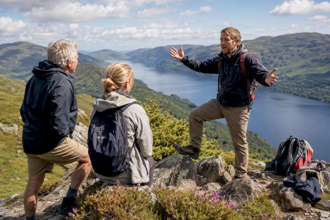 Local guide explaining coastal view to tourists