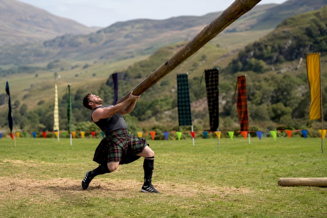 Athlete tossing caber log in Highland Games