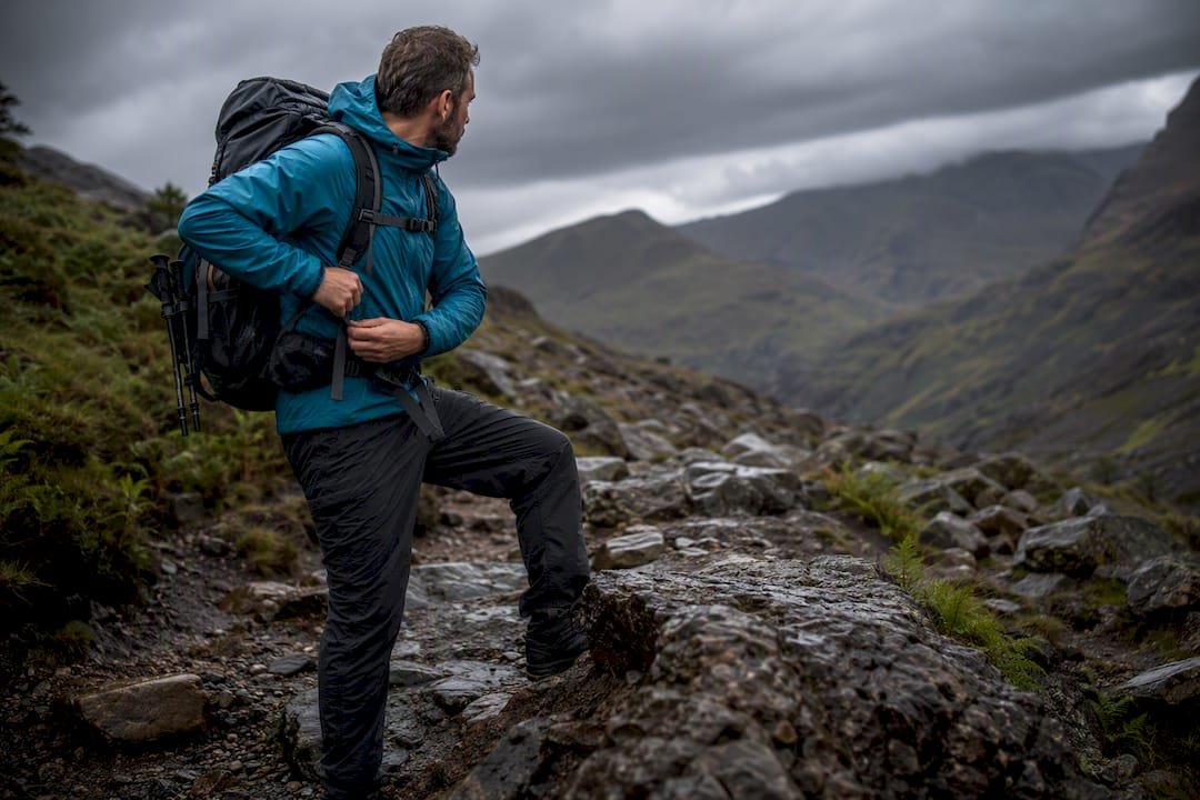 Mountain guide assessing rocky path conditions