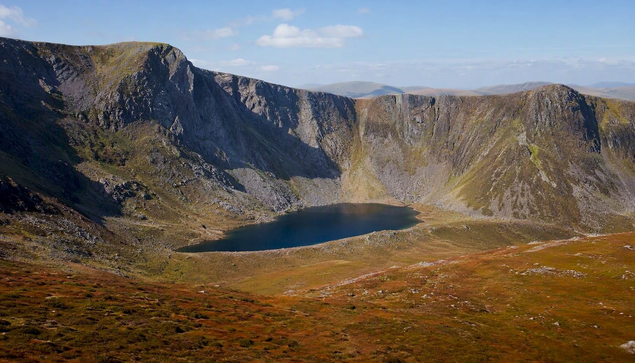 Mountain corrie with lochan and steep cliff backwall