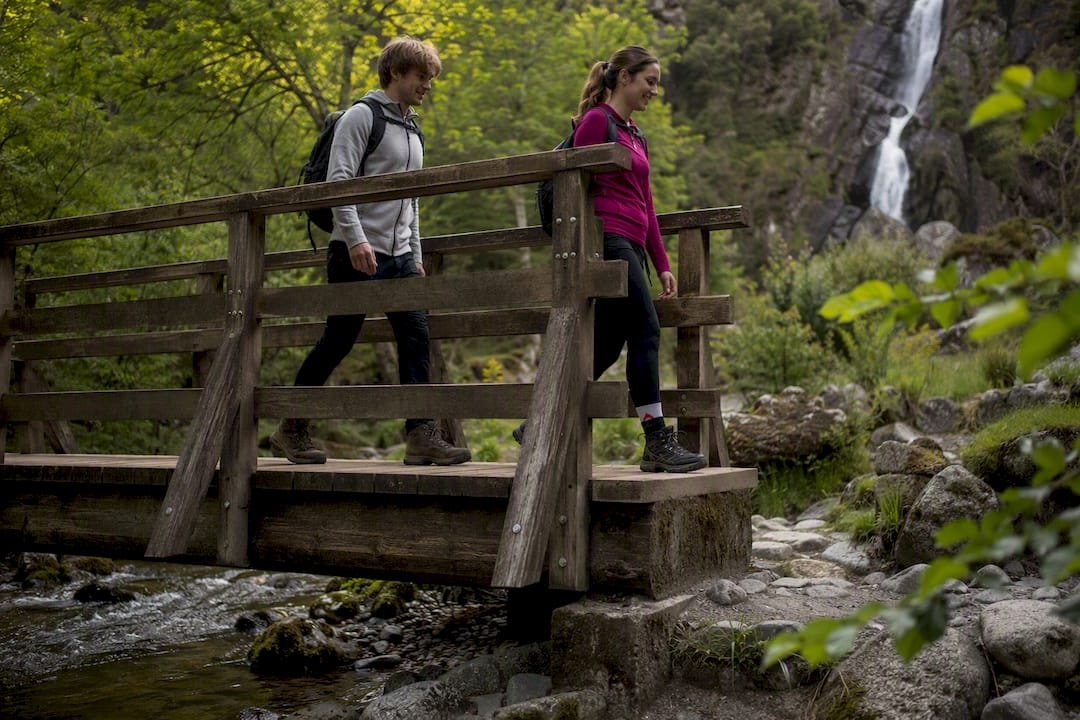 Hikers crossing footbridge in Steall Falls gorge