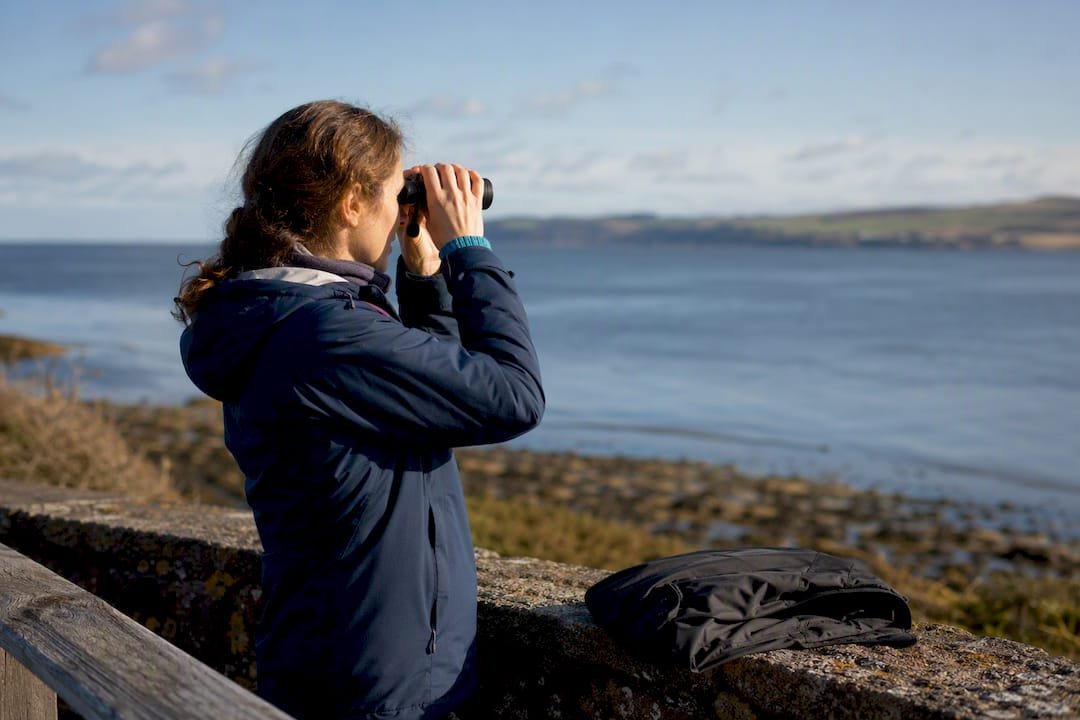 Visitor watching Moray Firth from shore