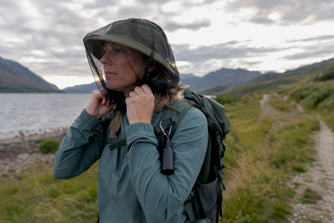 Traveler fitting a midge head net outdoors